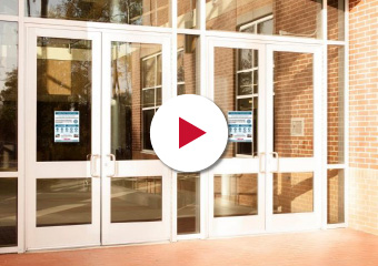 School doors with COVID notices